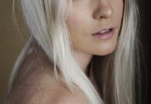 Strumming the place with her fingers